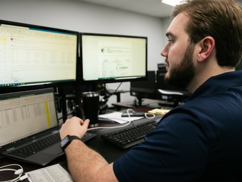 Greentech Renewables Employee at the Computer